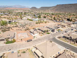 Aerial view of property's location with nearby suburban area and a mountain backdrop