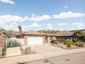 Single story home featuring stone siding, concrete driveway, and an attached garage