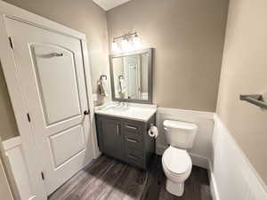 Hall Full Bathroom with Custom vanity, Quartz countertop, LVP-floors, and wainscoting.