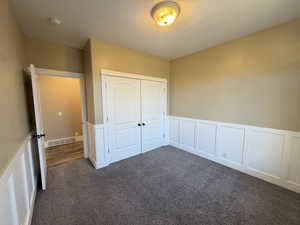 Bedroom 2/5, large double closet, premium carpet and wainscoted walls.