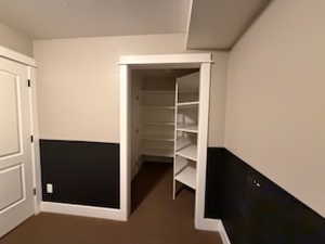 Open closet/storage area and the door in closet/storage area leads to the cold storage area.