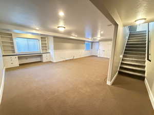 Stairs to bsmnt family room, with built in hobby/craft/writing desk