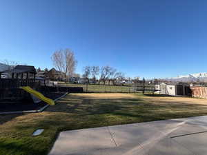 Fenced backyard with a storage unit