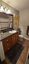 Full bsmnt bathroom with vanity, dark tile patterned floors and tub-shower