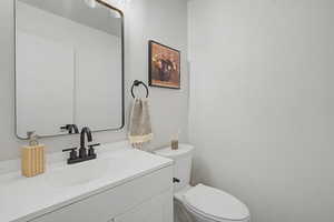 Half bath with vanity and toilet