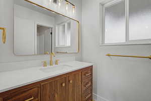 Bathroom with vanity and baseboards
