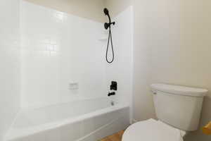 Full bath with  shower combination and light wood finished floors