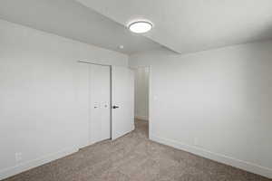 Unfurnished bedroom with carpet and a closet