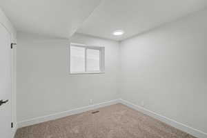 Spare room with carpet and a textured ceiling