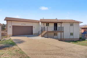 Ranch-style house with an attached garage, concrete driveway, and brick siding