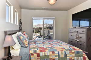 Bedroom featuring access to exterior and a textured ceiling