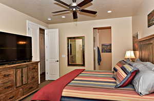 Bedroom featuring ceiling fan, recessed lighting, and a textured ceiling