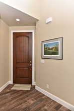 Foyer with dark wood-style floors and recessed lighting