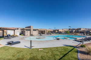 Community pool featuring a patio, a lawn, and a residential view
