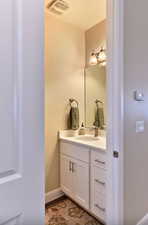 Bathroom with vanity and baseboards