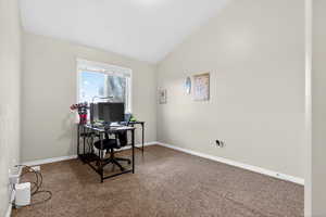 Office area featuring vaulted ceiling and carpet