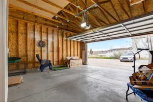 Garage featuring a garage door opener and a residential view