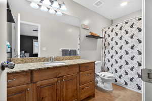 Full bathroom with a shower with curtain, vanity, and light tile patterned flooring