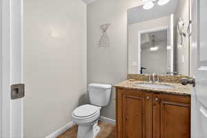 Half bathroom featuring vanity and light tile patterned flooring