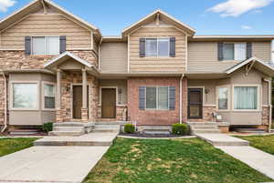 Craftsman inspired home with a front yard and stone siding
