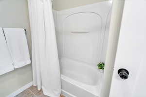 Full bathroom featuring tile patterned flooring and shower / bath combo
