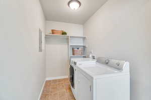 Laundry area featuring baseboards and washer and dryer