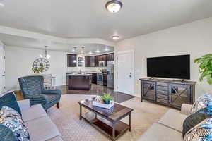 Living room with baseboards and suspended lighting