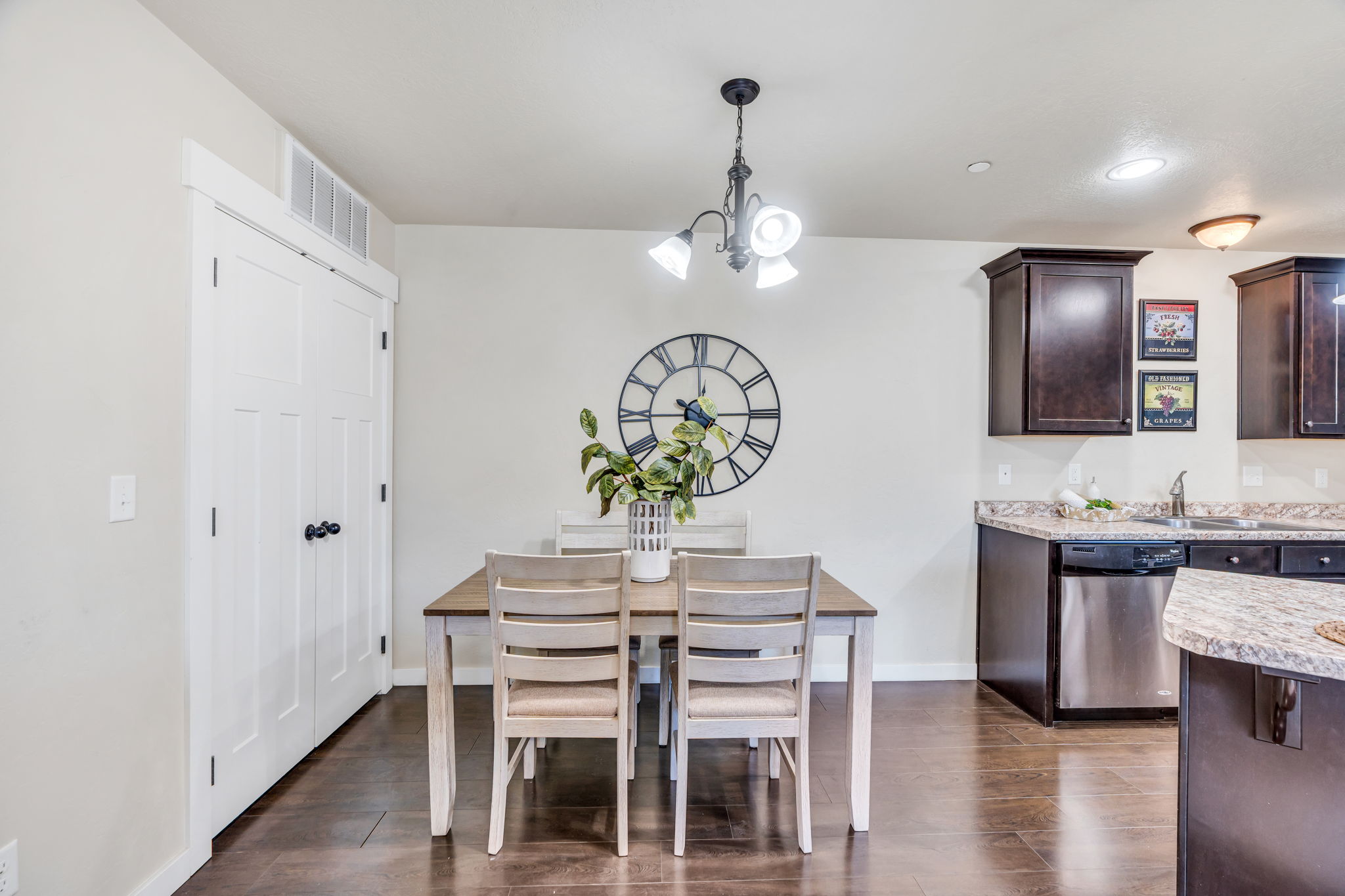 Dining space featuring hanging lights and dark wood-style floors