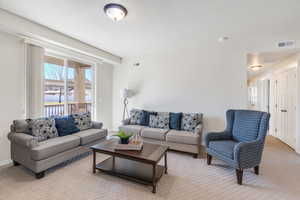 Living room featuring light carpet