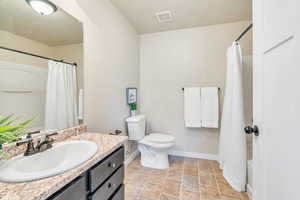 Bathroom with vanity and shower / tub combo with curtain