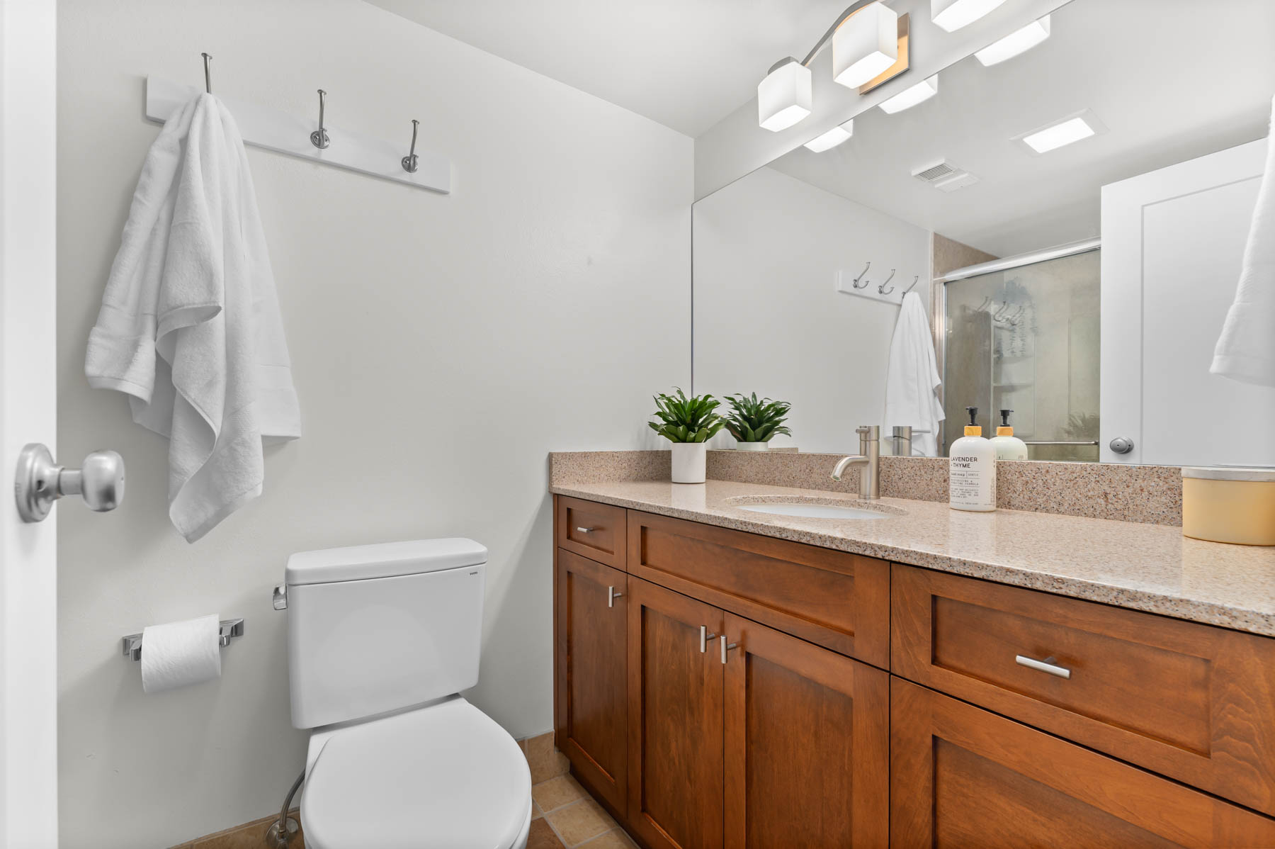 Bathroom featuring vanity and a shower stall