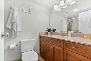 Bathroom featuring vanity and a shower stall