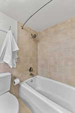 Full bathroom with  shower combination, tile walls, and light tile patterned flooring