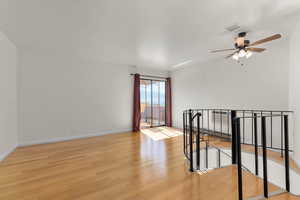 Unfurnished room with light wood-style flooring and a ceiling fan