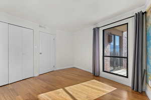 Unfurnished bedroom featuring crown molding and light wood-type flooring