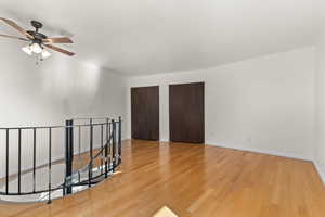 Spare room with light wood-type flooring and a ceiling fan