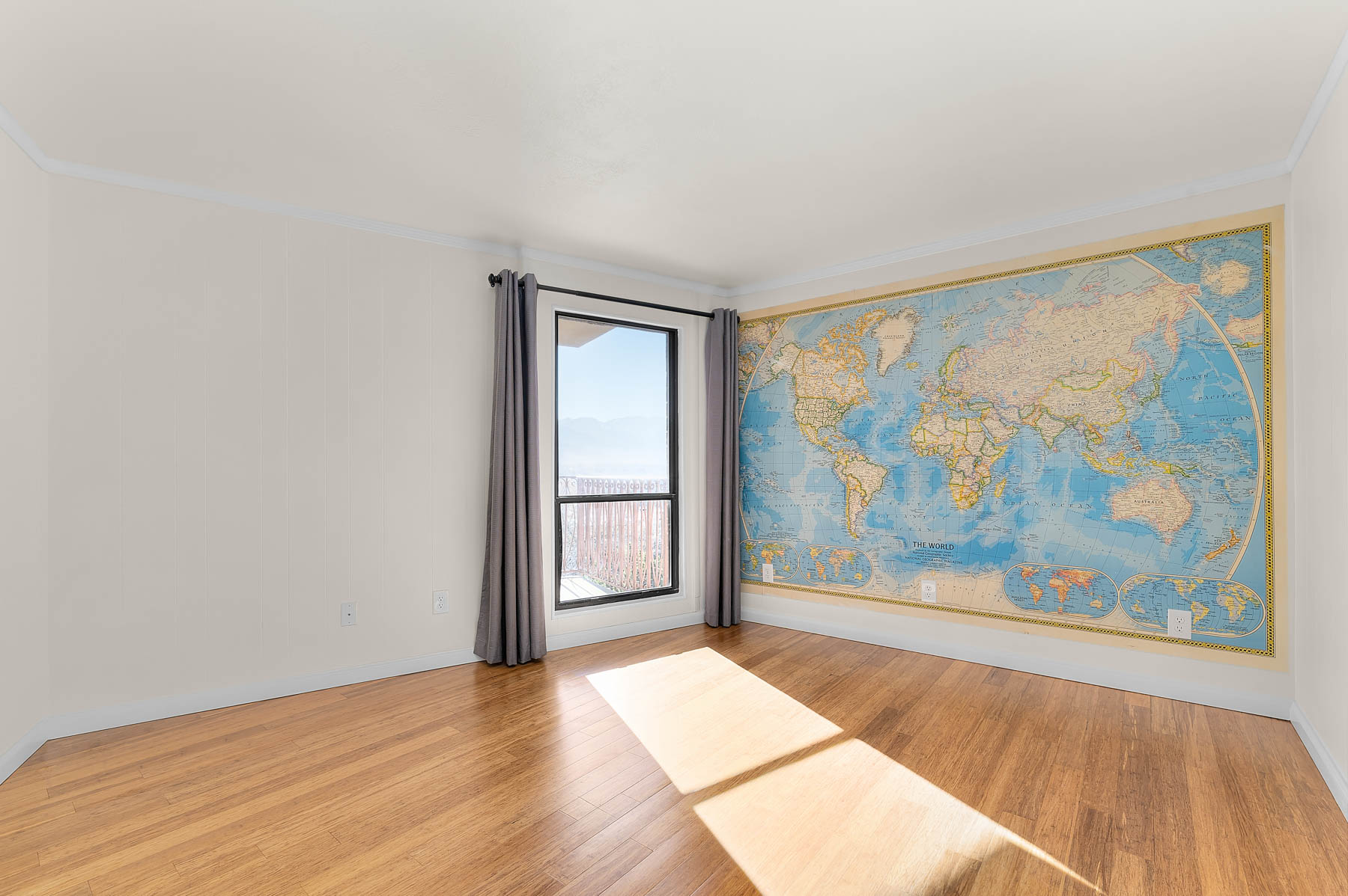 Unfurnished room with light wood-style floors and ornamental molding
