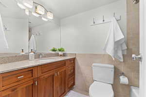 Bathroom featuring vanity and tile walls
