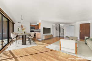 Living area featuring stairs and light wood-style flooring