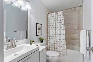 Full bathroom featuring vanity and shower / bath combination with curtain