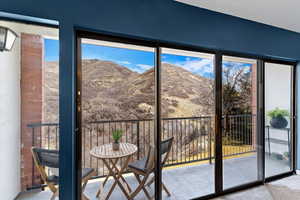 Doorway with a mountain view and carpet floors