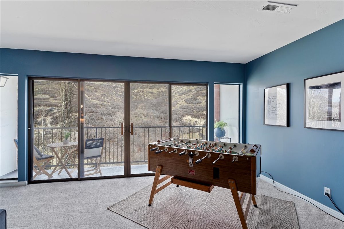 Game room with carpet and baseboards