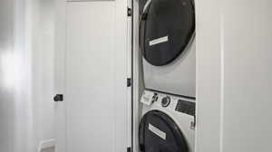 Laundry area featuring stacked washing machine and dryer