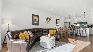 Living room featuring light wood-style flooring and recessed lighting