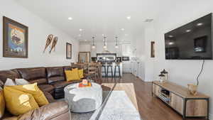 Living area with wood finished floors and recessed lighting
