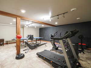 Workout area with track lighting and baseboards