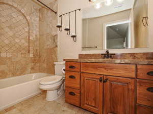 Full bathroom with vanity, shower / bath combination, and light tile patterned flooring