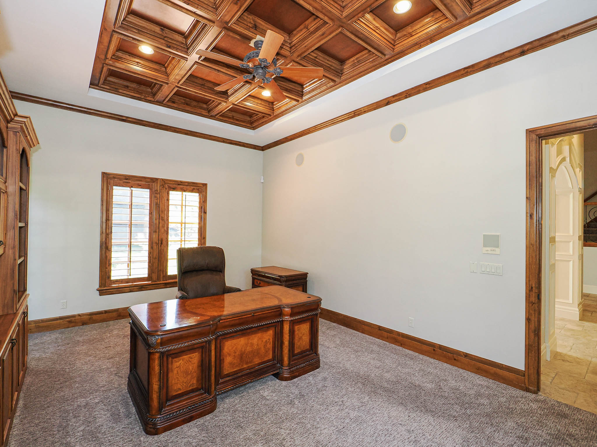 Office with crown molding, coffered ceiling, a ceiling fan, recessed lighting, and carpet floors