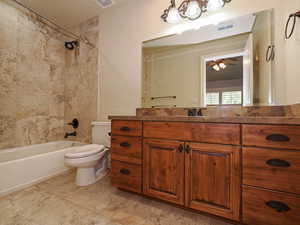 Full bathroom with vanity, shower / bathtub combination, and ceiling fan