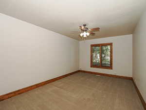 Unfurnished room featuring light colored carpet and a ceiling fan